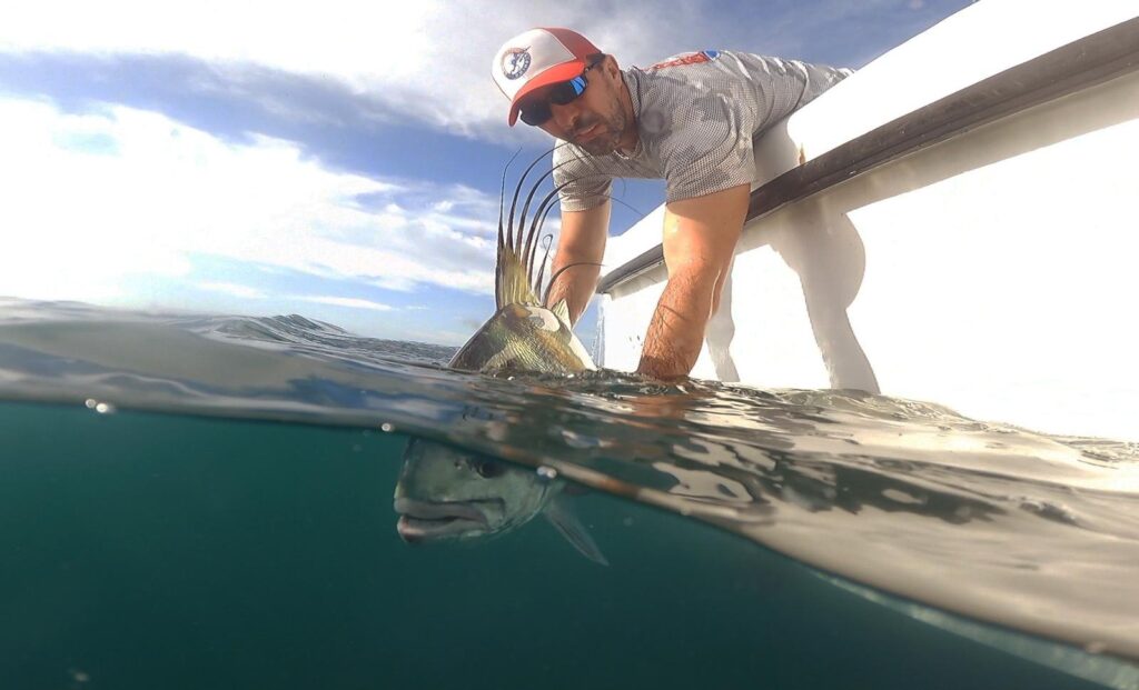 Central America Fishing owner, Chris, releases a roosterfish in Panama